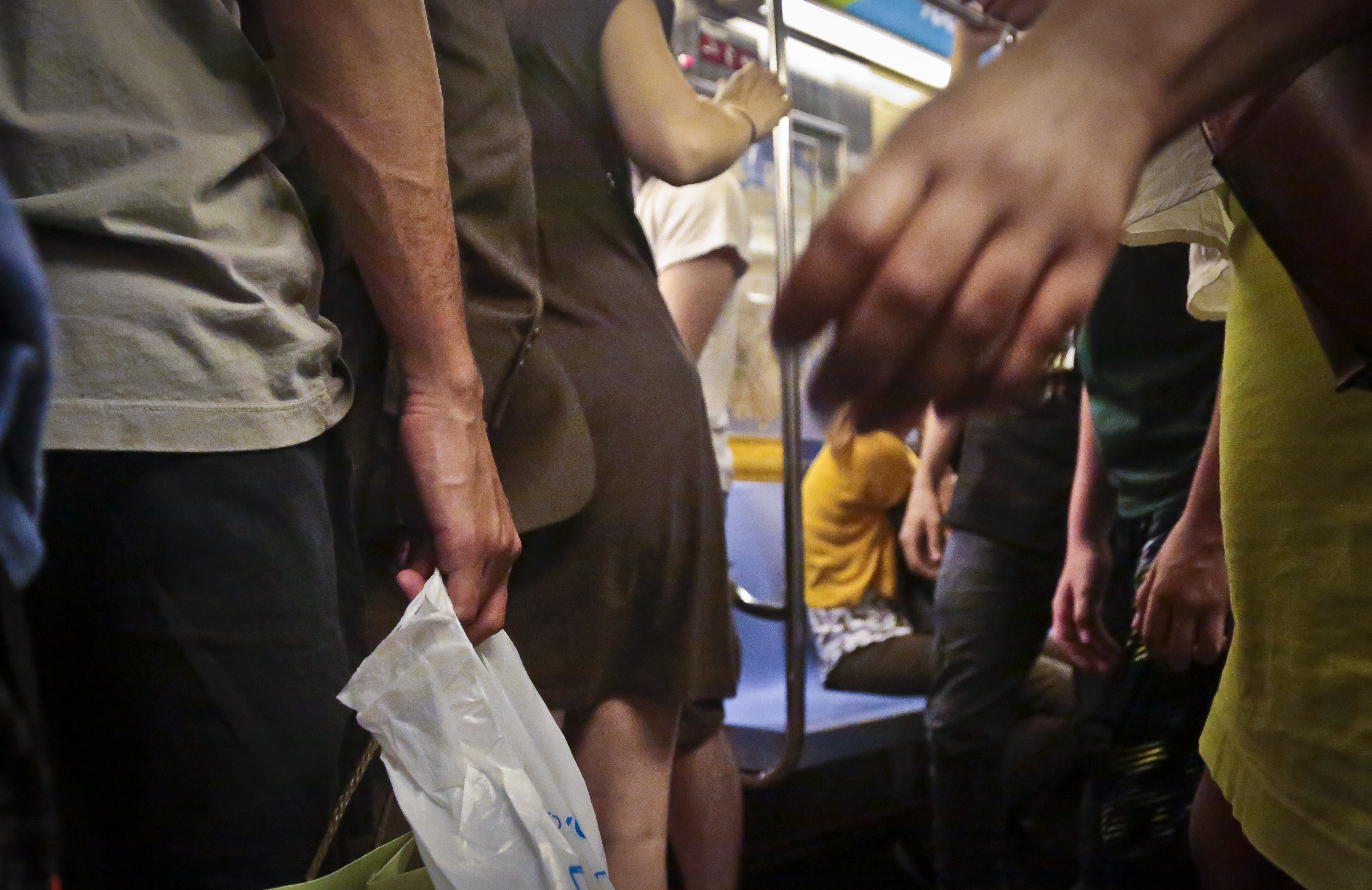 Subway riders board a train during rush hour, Wednesday, June 22, 2016, in ...