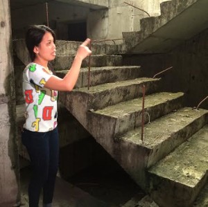 Witness Regine Dioliste, daughter of a building caretaker, points at where she hid when Lorenzo Peña came and started throwing things inside the stockroom and kitchen of an unfinished Makati City building. Peña's body was found on the fifth  level basement of the same building last June 27, 2016. (Photo by Erika Sauler, INQUIRER)  