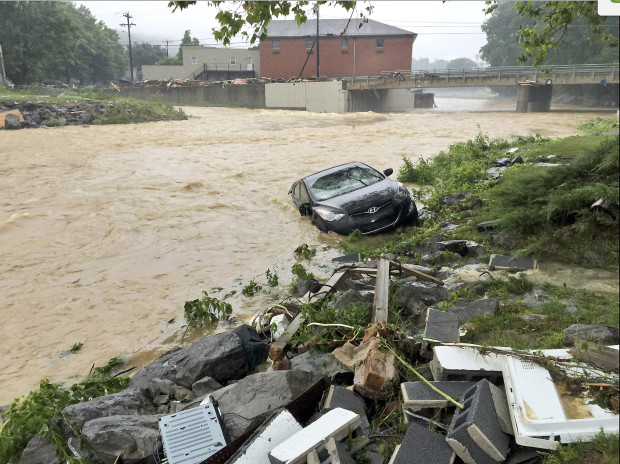 In this photo released by the The Weather Channel, a vehicle rests on the in a stream after a heavy rain near White Sulphur Springs, W.Va., Friday, June 24, 2016. Multiple fatalities have been reported in flooding that has devastated parts of the state, a state official said Friday morning. AP
