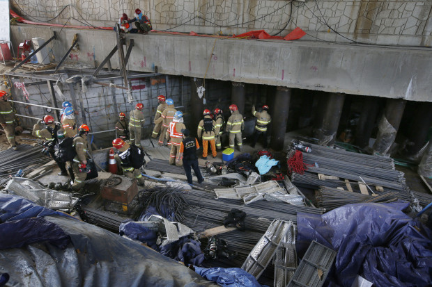Rescue workers search for survivors after an explosion at a subway construction site in Namyangju, South Korea, Wednesday, June 1, 2016. Officials from the Gyeonggi Province Fire and Disaster Headquarters said the workers were underground when the explosion occurred Wednesday morning. (Lim Byung-shick/Yonhap via AP) KOREA OUT