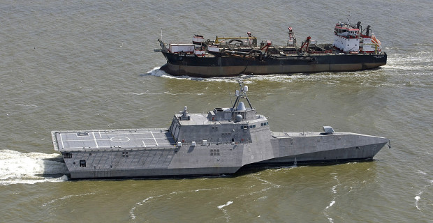 FILE - In this March 24, 2010, file photo, the littoral combat ship USS Independence, foreground, passes another vessel as it makes its way south through the waters of Mobile Bay, Ala. The Navy spent hundreds of millions of taxpayer dollars to fulfill its need for speed with the fast and agile warships like the Independence. The gee-whiz factor of the ships, designed to meet unconventional threats and to operate in shallow coastal waters, has been overshadowed by concerns over costs and survivability during combat. (G.M. Andrews/AL.com via AP)  MAGS OUT; MANDATORY CREDIT