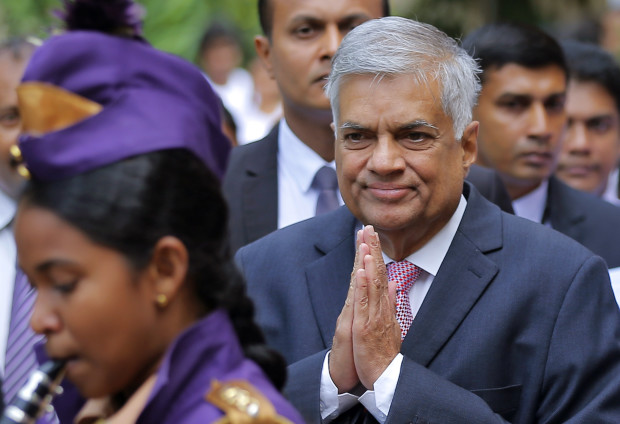 Sri Lankan Prime Minister Ranil Wickremesinghe attends an event before going to Parliament for discussion and probable vote on a bill presented by him on right to information in Colombo, Sri Lanka, Friday, June 24, 2016. Sri Lankan lawmakers are close to giving citizens the right to demand public information, a move many hope will restore transparency and good governance to a nation that has for long been plagued by corruption and misrule. (AP Photo/Eranga Jayawardena)