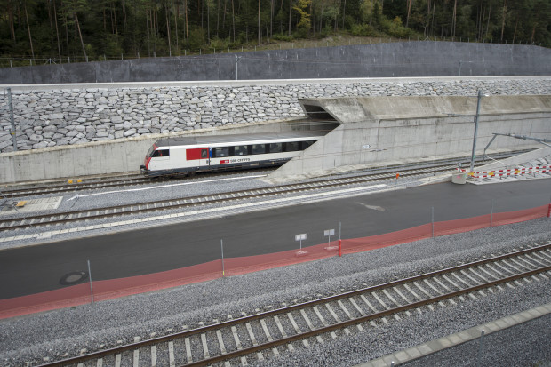 FILE - In this Oct. 8, 2015 file photo a test train drives close to the northern gate near Erstfeld, Switzerland. The celebrations of the opening of the Gotthard  Base Tunnel  will start on June 1, 2016. With a length of 57 km (35 miles) crossing the Alps, the Gotthard Base tunnel is the  world's longest train tunnel. (Urs Flueeler/Keystone via AP, file)