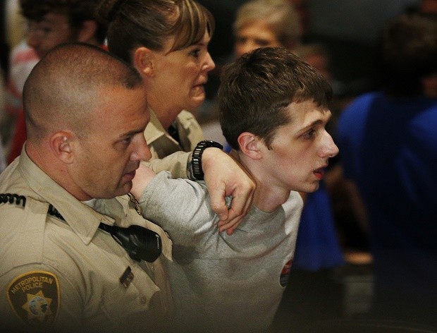 In this June 18, 2016, photo, police remove Michael Steven Sandford as Republican presidential candidate Donald Trump speaks at the Treasure Island hotel and casino in Las Vegas. Sandford, a British man accused of trying to take a police officer's gun and kill Donald Trump during a weekend rally in Las Vegas, will not be released on bail. Federal Magistrate Judge George Foley said at a hearing Monday that Sandford was a potential danger to the community and a flight risk. AP 