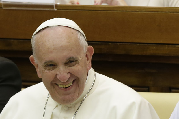 Pope Francis smiles as he arrives to attend a two-day summit of judges and magistrates against human trafficking and organized crime, at the Vatican, Friday, June 3, 2016. Judges and prosecutors from around the world are pledging to crack down on human trafficking and help victims of modern-day slavery in the latest Vatican initiative to draw attention to the problem and rally resources to fight it. (AP Photo/Gregorio Borgia)