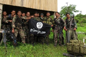 This photo taken on June 3, 2016 shows Philippine soldiers displaying the flag used by the Islamic State group after overrunning a militant camp at a remote village in Butig town, Lanao del Sur province, in the southern Philippine island of Mindanao.  Philippine troops captured an Islamic militant training camp after a 10-day battle, officials said, as part of operations to clear insurgents from a remote jungle region. AFP PHOTO