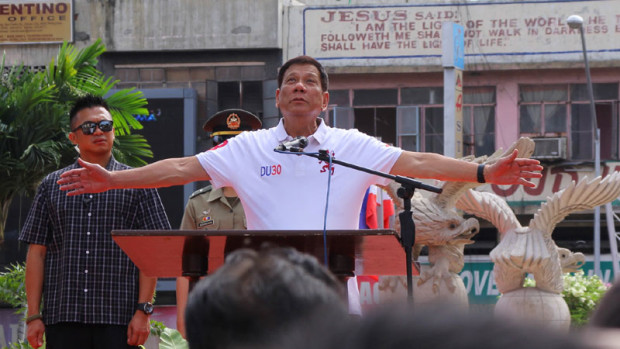 A LA UP OBLATION     Incoming President Rodrigo Duterte strikes a pose like the UP Oblation  at the flag-raising ceremony at Davao City Hall. Duterte, a known night person who had not attended the regular Monday event for a long time, spoke of his impending war on illegal drugs, crime and corruption. ACE MORANDANTE/CONTRIBUTOR