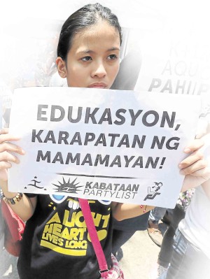 A PROTESTER holds a poster expressing many students’ sentiments on the K-12 program at a recent rally against additional high school years in front of the Department of Education office in Pasig City.  GRIG C. MONTEGRANDE