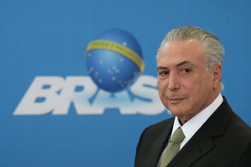 Brazil's acting President Michel Temer arrives for the inauguration ceremony of new presidents of state companies, at Planalto presidential palace in Brasilia, Brazil, Wednesday, June 1, 2016. The new president of the state oil company Petrobras is Pedro Parente; the new president of the National Bank of Social Development is Maria Silvia Bastos; and the new president of the Bank of Brazil is Paulo Rogerio Caffarelli. AP PHOTO