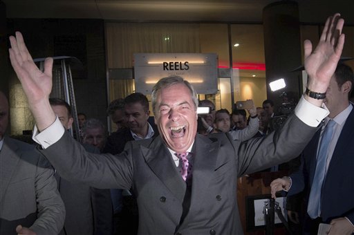 Nigel Farage, the leader of the UK Independence Party, celebrates and poses for photographers as he leaves a "Leave.EU" organization party for the British European Union membership referendum in London, Friday, June 24, 2016. On Thursday, Britain voted in a national referendum on whether to stay inside the EU.  (Stefan Rousseau/PA via AP) 