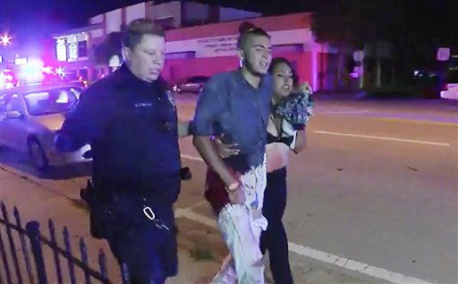 An injured man is escorted out of the Pulse nightclub after a shooting rampage, Sunday morning June 12, 2016, in Orlando, Fla. A gunman wielding an assault-type rifle and a handgun opened fire inside a crowded gay nightclub early Sunday, killing at least 50 people before dying in a gunfight with SWAT officers, police said. It was the deadliest mass shooting in American history. AP Photo