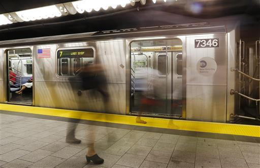 People walk on the platform for the 7 Line train, Wednesday, June 22, 2016, in New York. Gov. Andrew Cuomo says more needs to be done to curb a rise in sex offenses in the New York City subway system. (AP Photo/Frank Franklin II) 