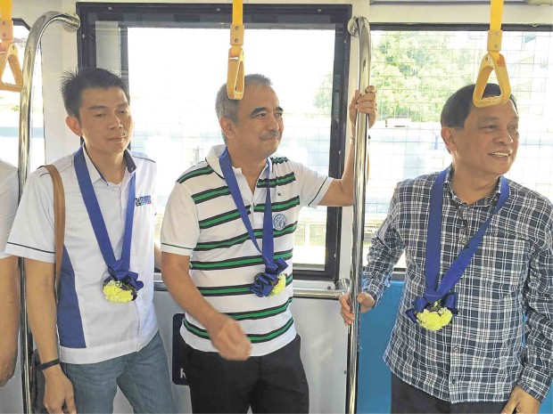 HI-TECH GOES LOCO. The DOST’s newly developed hybrid train easily outshines the old locomotives of the Philippine National Railways when formally unveiled on Saturday at PNR Tutuban station in Manila, with Science Secretary Mario Montejo among its first, proud passengers (inset, top). MARIANNE BERMUDEZ