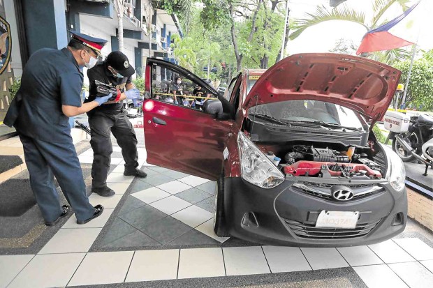 THE ROAD rage suspect’s vehicle is examined for fingerprints at Camp Crame on Thursday. Gric C. Montegrande