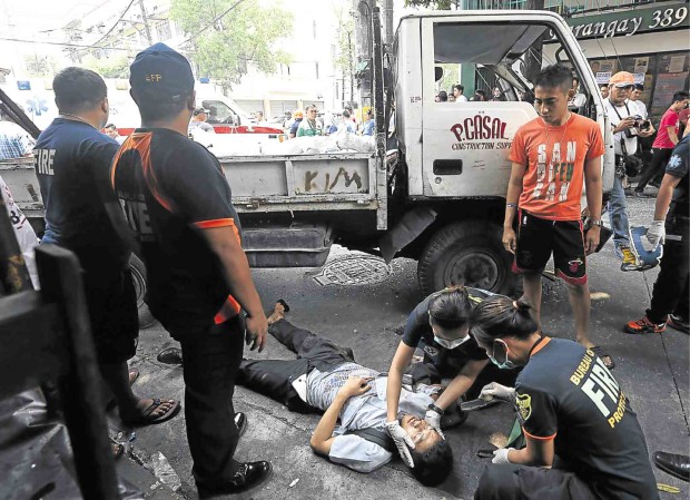 RESCUERS attend to one of the injured students on Friday.           MARIANNE BERMUDEZ