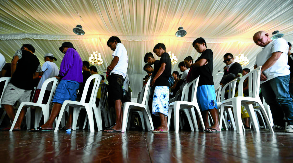 PROJECT TOKHANG/JULY 01, 2016 Drug users from different barangays in Taguig City who had voluntarily surrendered and signed certificates to cease their involvement in illegal drugs pray during the launching of Project Tokhang at the Lakeshore Tent, Barangay Lower Bicutan in Taguig City. INQUIRER PHOTO/LYN RILLON