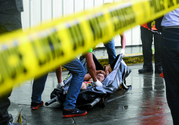 July 9, 2016 Manila- A body of a man suspected to be a drug peddler is found in front of the Metropolitan Theather in Manila early saturday morning, police are still investigating the identity of the person. INQUIRER/ MARIANNE BERMUDEZ