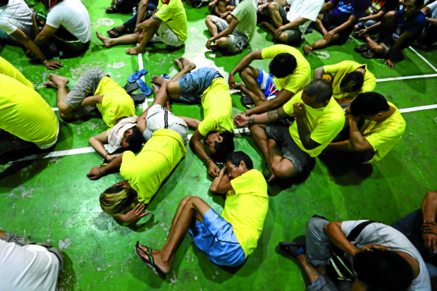 Detainees sleep on the floor as they await processing during the operations targeting drug personalities, persons with warrant of arrest and violators of city ordinances of the PNP Eastern Police District  covering the area of Pasig, Marikina, Mandaluyong and San Juan City at the EPD Headquarters in Pasig. 198 people were arrested during the operations.INQUIRER PHOTO/RAFFY LERMA 