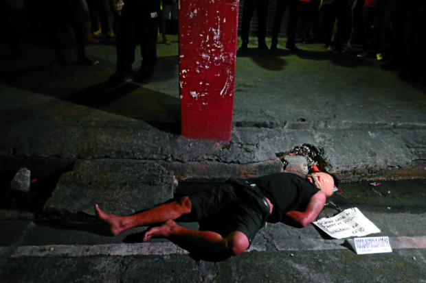 he body of an alleged drug pusher and robber, whose face is wrapped in packaging tape, hands bound and stabbed several times in the chest is found along Lerma Street, Sampaloc, Manila.INQUIRER PHOTO/RAFFY LERMA 