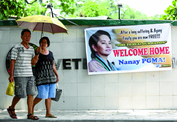 Visitors pass by a message of support for Representative and former Pres. Gloria Macapagal Arroyo outside Veterans Memorial Medical Center's in Quezon City where she still remains. The Supreme Court ordered her release from hospital arrest yesterday after an 11-4 vote dismissing plunder charges against her. INQUIRER PHOTO/LYN RILLON