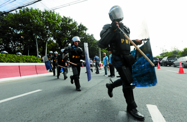 TIGHT SECURITY / JULY 25, 2016Members of the PNP anti-riot squad with their shield and trancheons take up position outside the House of Representatives along IBP Road in Quezon City prior to the State of the Nation Address (SONA) of President Rodrigo Roa Duterte on Monday, July 25, 2016. INQUIRER PHOTO / GRIG C. MONTEGRANDE