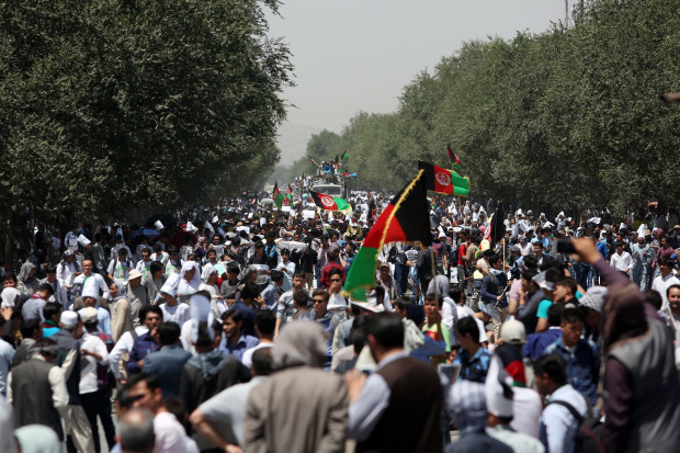 Protesters march during a massive anti-government protest in Kabul, Afghanistan, Saturday, July 23, 2016. Afghan authorities have closed off streets across the capital, Kabul as they prepare for a demonstration by ethnic Hazaras demanding a planned power line be rerouted through their poverty-stricken province. (AP Photo/Rahmat Gul)