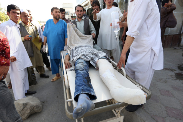 Afghans help an injured man after an explosion struck a protest in Kabul, Afghanistan, Saturday, July 23, 2016. Witnesses in Kabul say that an explosion struck the protest march by members of Afghanistan’s largely Shiite Hazara ethnic minority group, demanding that a major regional electric power line be routed through their impoverished home province. (AP Photo/Rahmat Gul)