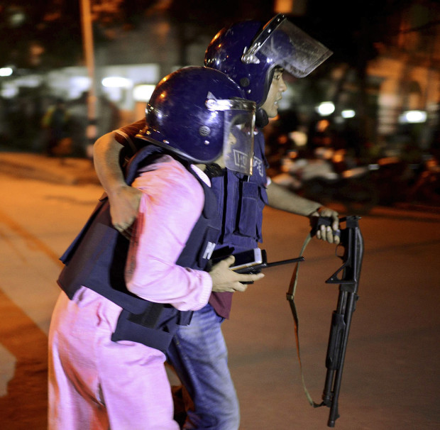 An unidentified security personnel is taken for medical attention after a group of gunmen attacked a restaurant popular with foreigners in a diplomatic zone of the Bangladeshi capital Dhaka, Bangladesh, Friday, July 1, 2016. A group of gunmen attacked a restaurant popular with foreigners in a diplomatic zone of the Bangladeshi capital on Friday night, taking hostages and exchanging gunfire with security forces, according to a restaurant staff member and local media reports. AP 