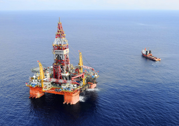 FILE - In this May 7, 2012 file photo released by China's Xinhua News Agency, Haiyang Shiyou oil rig, the first deep-water drilling rig developed in China by the China National Offshore Oil Corporation, is pictured at 320 kilometers (200 miles) southeast of Hong Kong in the South China Sea. Two state-owned companies, China General Nuclear Power Group and China National Nuclear Corp., have announced plans to develop floating nuclear reactors for use by oil rigs or island communities. If they succeed, the achievement would raise concern the reactors might be sent into harm’s way to support oil exploration in the South China Sea, where Beijing faces conflicting territorial claims by neighbors including Vietnam and the Philippines. (Jin Liangkuai/Xinhua News Agency via AP, File) NO SALES