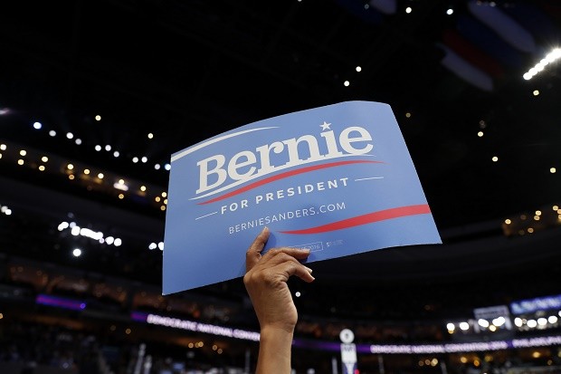 In this July 25, 2016, photo, a supporter for former Democratic Presidential candidate, Sen. Bernie Sanders, I-Vt., holds up a sign during the first day of the Democratic National Convention in Philadelphia. As Democrats rally around Hillary Clinton, the lingering “Bernie or Bust” movement is stirring frustration at the Democratic convention among delegates of color, who say they’re upset at the refusal of the Vermont senator’s most fervent backers to fall in line behind the party’s nominee. AP