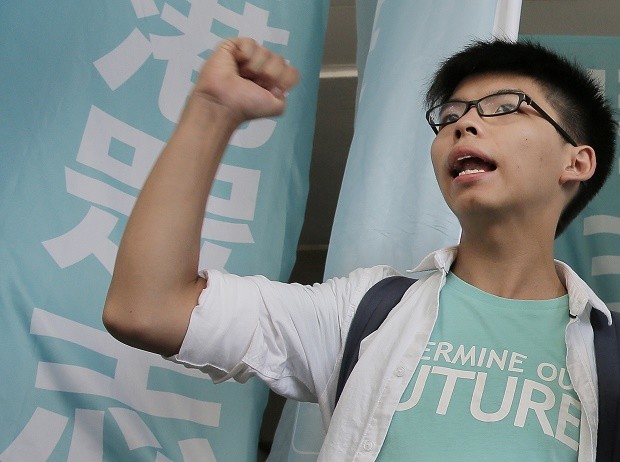 Teen protest leader Joshua Wong shouts slogans outside a magistrate's court in Hong Kong, Thursday, July 21, 2016. A Hong Kong court on Thursday found teen protest leader Wong guilty of taking part in an illegal rally that sparked massive student-led pro-democracy protests two years ago. AP 