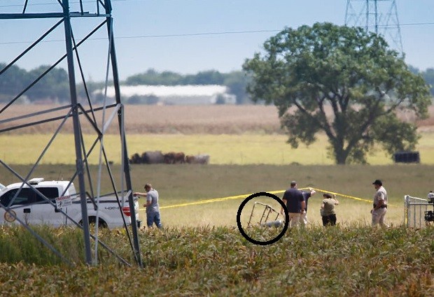 Investigators surround the scene in a field near Lockhart, Texas where a hot air balloon carrying at least 16 people collided with power lines Saturday, July 30, 2016,  causing what authorities described as a "significant loss of life."  (Ralph Barrera/Austin American-Statesman via AP)
