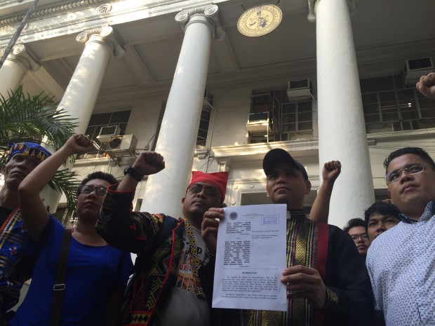 Some members of the Haran 15 shows the DOJ resolution dismissing the kidnapping and serious illegal detention case against them. /Tetch Torres-Tupas, INQUIRER.net