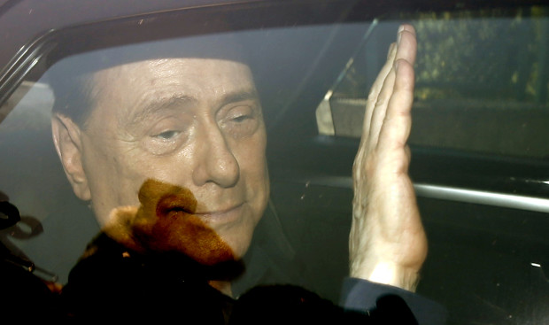 FILE -  in this Friday, July 18, 2014 file photo, Italy's former Premier Silvio Berlusconi waves as he leaves the 'Sacra Famiglia' institute in Cesano Boscone, Italy. Media mogul Silvio Berlusconi, who served three times as Italian premier, was undergoing heart surgery Tuesday June 14, 2016 at a Milan hospital. (AP Photo/Luca Bruno, File)