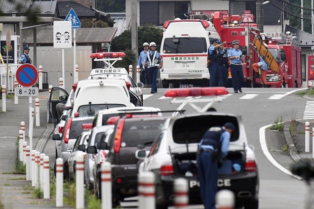 Police officers stand by with ambulances and firetrucks seen on a street near a facility for the handicapped where a number of people were killed and dozens injured in a knife attack Tuesday, July 26, 2016, in Sagamihara, outside Tokyo. AP