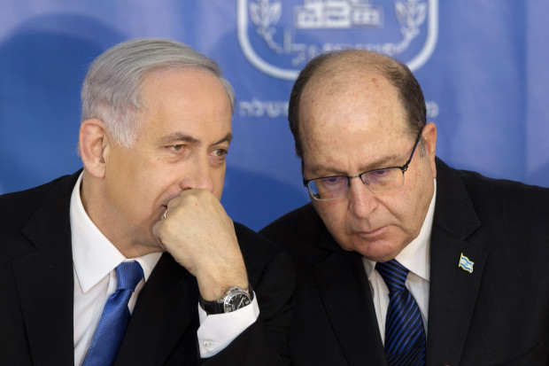FILE - In this Monday, Feb. 16, 2015 file photo, Israeli Prime Minister Benjamin Netanyahu, left, speaks with Israel's Defense Minister Moshe Yaalon during a ceremony for new Israeli Chief of Staff Gadi Eizenkot at the Prime Minister's office in Jerusalem. Israel's newly resigned defense minister has accused Prime Minister Benjamin Netanyahu of exaggerating the country's security threats to distract attention from other issues. (AP Photo/Sebastian Scheiner, File)
