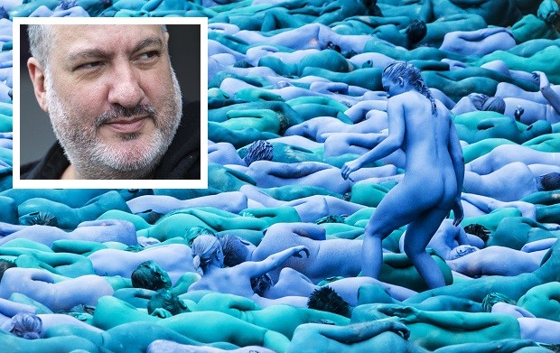 EDS NOTE: NUDITY NO CROPPING ALLOWED.  People manoeuvre into position as they take part in a mass nude art installation entitled Sea of Hull by New York based artist Spencer Tunick in Hull, England, Saturday July 9, 2016. Thousands of people stripped nude and are painted various shades of blue to participate in a huge installation at various locations in the sea side city on England's east coast, celebrating the citys maritime heritage. (Danny Lawson / PA via AP)  EDS NOTE: NO CROPPING ALLOWED - NO COMMERCIAL USE - UNITED KINGDOM OUT - NO SALES - NO ARCHIVE