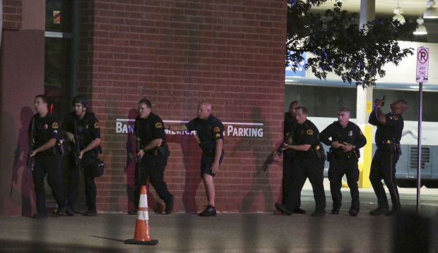 Dallas police respond after shots were fired  during a protest over recent fatal shootings by police in Louisiana and Minnesota, Thursday, July 7, 2016, in Dallas. Snipers opened fire on police officers during protests; several officers were killed, police said. AP
