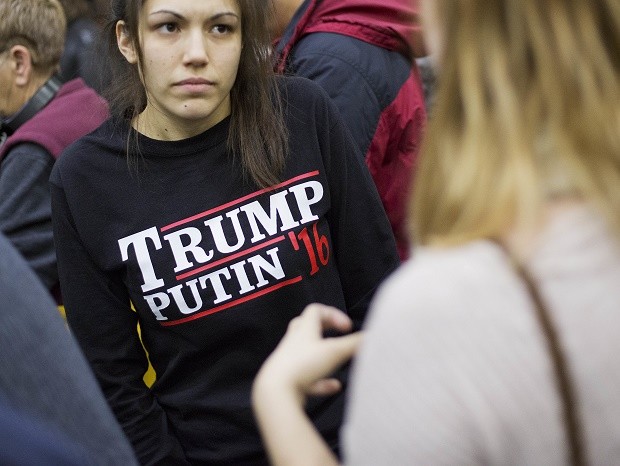In this Sunday, Feb. 7, 2016 file photo, a woman wears a shirt reading 'Trump Putin '16' while waiting for Republican presidential candidate Donald Trump to speak at a campaign event at Plymouth State University in Plymouth, N.H. Donald Trump just keeps giving Russian President Vladimir Putin more reasons to hope he wins the U.S. election, while raising serious questions about the Republican candidate’s intentions toward the Kremlin. In his most recent outreach to Putin, Trump not only refused to condemn Russia’s military takeover of Ukraine’s Crimean Peninsula but said, if elected, he would consider recognizing it as Russian territory and lifting sanctions against Moscow. “We'll be looking at that. Yeah, we'll be looking,” Trump told reporters on Wednesday, July 27, 2016.  AP FILE PHOTO 
