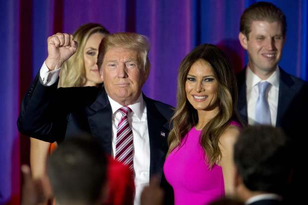 FILE - In this June 7, 2016 file photo, Republican presidential candidate Donald Trump gestures to supporters as he leaves the stage with his wife Melania after a news conference at the Trump National Golf Club Westchester in Briarcliff Manor, N.Y. Melania Trump insists she’s her own person, more than an accessory in her husband Donald Trump’s run for the White House.   (AP Photo/Mary Altaffer)