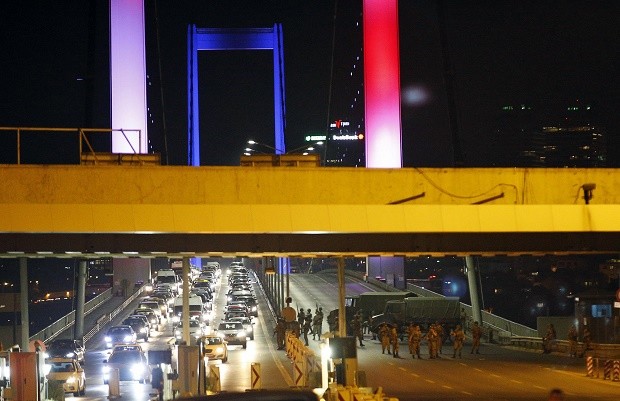 Turkish soldiers block Istanbul's iconic Bosporus Bridge on Friday, July 15, 2016, lit in the colours of the French flag in solidarity with the victims of Thursday's attack in Nice, France. A group within Turkey's military has engaged in what appeared to be an attempted coup, the prime minister said, with military jets flying over the capital and reports of vehicles blocking two major bridges in Istanbul. Prime Minister Binali Yildirim told NTV television: "it is correct that there was an attempt," when asked if there was a coup. AP 