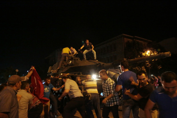 Tanks move into position as Turkish people attempt to stop them, in Ankara, Turkey, late Friday, July 15, 2016. Turkey's armed forces said it "fully seized control" of the country Friday and its president responded by calling on Turks to take to the streets in a show of support for the government. A loud explosion was heard in the capital, Ankara, fighter jets buzzed overhead, gunfire erupted outside military headquarters and vehicles blocked two major bridges in Istanbul. AP 