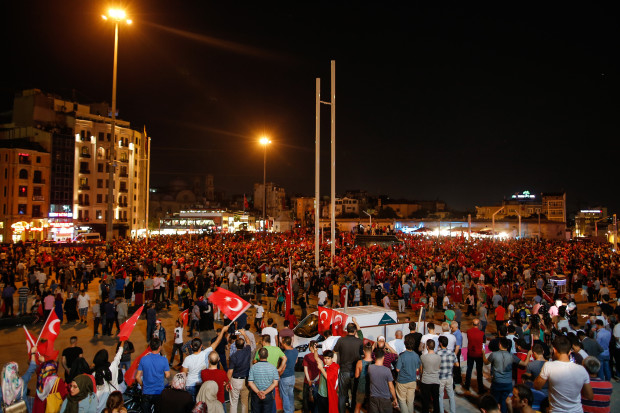 People gather at a pro-government rally in central Istanbul's Taksim square, Saturday, July 16, 2016. Forces loyal to Turkish President Recep Tayyip Erdogan quashed a coup attempt in a night of explosions, air battles and gunfire that left some hundreds of people dead and scores of others wounded Saturday.  (AP Photo/Emrah Gurel)