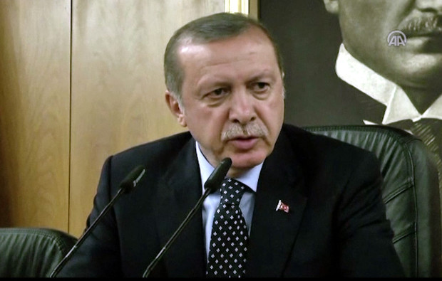 In this image taken from video provided by Anadolu Agency, Turkish President Recep Tayyip Erdogan speaks to the media Saturday, July 16, 2016 in Istanbul. Erdogan said that his government was working to crush a coup attempt after a night of explosions, air battles and gunfire that left dozens dead and at least 150 people wounded. (Anadolu Agency via AP)