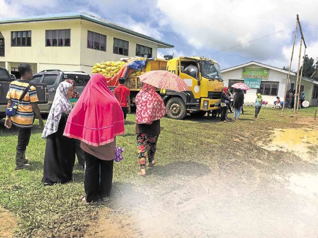 VILLAGERS from the Basilan towns of Al Barka, Tipo-Tipo and Ungkaya Puyan approach a truck loaded with relief goods as military operations against Abu Sayyaf displace scores of civilians from their homes.JULIE S. ALIPALA/INQUIRER MINDANAO