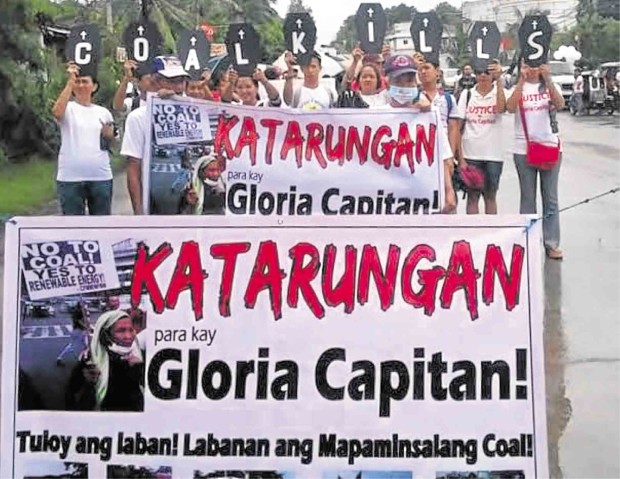 CALLS for justice ring out on Sunday during the burial of Gloria Capitan (inset), who fought to stop an open coal storage facility in Bataan. CONTRIBUTED PHOTOS