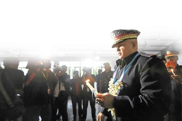 PHILIPPINE National Police chief, Director General Ronald “Bato” dela Rosa, holds a lighted candle during rites to bless a rehabilitation facility for drug dependents in Limay town, Bataan province, on July 8. NIÑO JESUS ORBETA