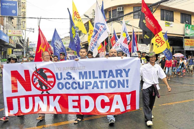 ANTI-EDCA protesters take to the streets of Cagayan de Oro City, near the Lumbia Airfield, one of the sites identified as a temporary US base. JIGGER JERUSALEM/INQUIRER MINDANAO