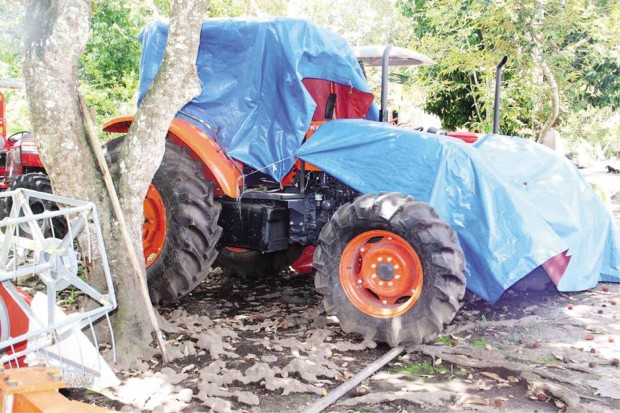 ONE of the agricultural machines left unused in DA offices nationwide is this farm tractor covered with tarpaulin in a DA lot in Tupi town, South Cotabato province. CONTRIBUTED PHOTO