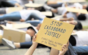 YOUTH leaders imitate victims of “cardboard justice” on Commonwealth Avenue, just meters away from the House of Representatives where the President was to deliver his State of the Nation Address. RAFFY LERMA